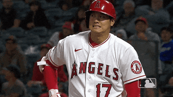 Sports gif. Shohei Ohtani of the LA Angels cringes and looks around him.