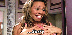 Music video gif. From the video for Mariah Carey's "Heartbreaker," an embarrassed Mariah sheepishly backs away after barging in on the wrong person. Text, "...Sorry."