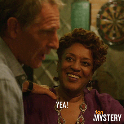 TV gif. CCH Pounder as Dr. Loretta Wade and Scott Bakula as Dwayne in NCIS: New Orleans. Dwayne clamps a hand on Dr. Loretta's shoulder and she bursts out laughing, putting a hand to her face.