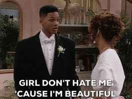 TV gif. Will Smith as Will in the Fresh Prince of Bel Air adjust the lapels on his tux as he turns toward a young woman beside him and says, "Girl, don't hate me 'cause I'm beautiful."