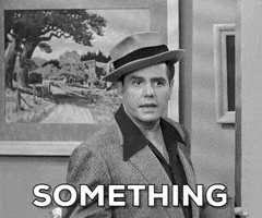 TV gif. Desi Arnaz as Ricky Ricardo in I Love Lucy wears a fedora and suit jacket while standing by an open door. Ricky says, “Something. Somehow. Somewhere,” each word emphasized by Ricky throwing a hand up, each more dramatic than the last.