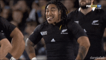 Sports gif. Ma'a Nonu and his teammates raise their fists and drop them to their sides in an energetic cheer. Ma'a's tongue is sticking out through his teeth.