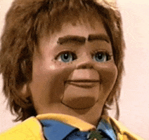 Video gif. A ventriloquist puppet opens its mouth and eyebrows at the same time, making a shocked and silly expression.
