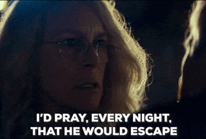 Movie gif. Jamie Lee Curtis as Laurie in Halloween in the dark with bright light on her hair so it's hard to see her face. She says with deep conviction, "I'd pray, every night, that he would escape."