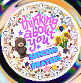 Digital art gif. A cake decorated with teddy bears and flowers reads the message, “Thinking about you. Sending Prayers.”