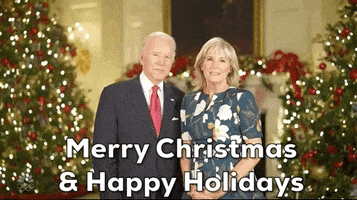 Political gif. Joe Biden and Jill Biden stand in the white house with several Christmas trees behind them. Joe says, “Merry Christmas and Happy Holidays.”