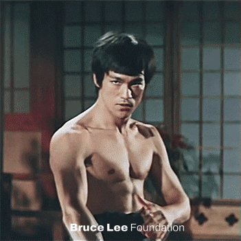 Bruce Lee gif. Bruce Lee, shortless and in a martial arts dojo, slowly moves his outstretched arms up and down in front of himself, undulating his hands as he stares into our souls. Trippy text that moves with his hands reads, "Empty your mind."