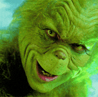 Movie gif. Closeup of Jim Carrey as the Grinch with an eerie smile spreading slowly across his face.