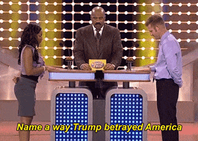 TV gif. Two contestants face off in front of Steve Harvey on Family Feud. Steve Harvey says, “Name a way Trump betrayed America.” The contestants slap the buzzer, the woman making it to the buzzer first. She says, “Espionage.” Steve Harvey points to the board where “Espionage” pops up on the ranking as the number two answer.
