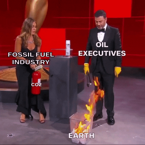 Celebrity gif. Jennifer Aniston labeled “Fossil Fuel Industry” and Jimmy Kimmel labeled “Oil Executives” stand in front of a burning trash can labeled Earth. Aniston sprays the trash can with a fire extinguisher labeled “CO2” as Kimmel attempts to pull a piece of the burning wreckage out of the trash can with tongs. It lights on fire again, and Aniston sprays it again.