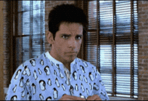 Movie gif. We zoom in on Ben Stiller as Derek Zoolander as he slowly smiles with surprise and then tosses his arm out as if to say, "You shouldn't have."