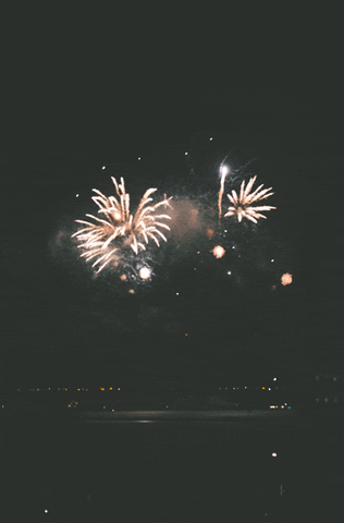 Video gif. Brilliant fireworks explode into a black sky and flood the night with dazzling light.