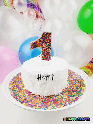 Animated graphic gif. Photo of a white cake with a rainbow sprinkle 1 on top of a base of rainbow sprinkles against a party-themed background. Multi-colored digital balloons float up around the cake with animated hand-written text that reads, "Happy Birthday."