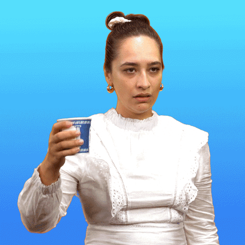 Video gif. Cartoon coffee oozes from a paper cup as a woman crushes it with one hand. Her lips quiver as she sighs, then scowls, and thrusts the cup down. As her anger rises, the background shifts from sky blue to a yellow and orange closeup of her face.