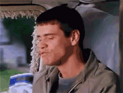 Movie gif. Jim Carrey as Lloyd in Dumb and Dumber laughs, then composes himself, attempting earnest seriousness. 