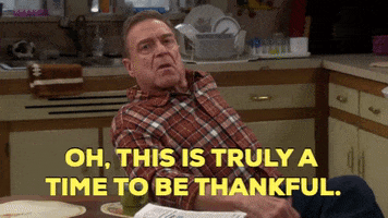 TV gif. John Goodman as Dan in The Conners. He sits at the kitchen table and throws his head back in relief, saying, "Oh, this is truly a time to be thankful!" as he slams his hand down and takes a deep breath. His eyes are closed the whole time and he does look very thankful.  