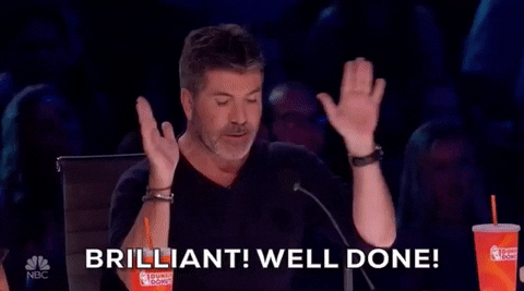 Reality TV gif. Simon Cowell on America's Got Talent raises his hands as if excited. Text, "Brilliant! Well done!"
