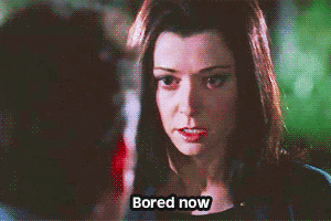 TV gif. Alyson Hannigan as Willow on Buffy The Vampire Slayer looks at a man with bored yet threatening eyes as she says, “Bored now.”