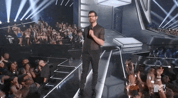 Celebrity gif. Billy Eichner at the 2022 Video Music Awards stands on a stage above a cheering crowd, raising his hand and saying, "Right?"