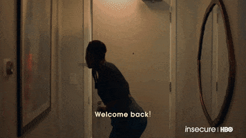TV gif. Issa Rae as Issa Dee opens her door to greet Amanda Seales as Tiffany, who holds a gift, on Insecure.