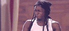 Celebrity gif. Lil Wayne cringes and then pushes his hair behind his ear nervously.