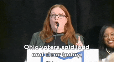 Video gif. Lauren Blauvelt, Vice President of Planned Parenthood of Greater Ohio stands behind a microphone and says, emphatically, "Yes, we support the reproduction of life and abortion access. Ohio voters said loud and clear today."