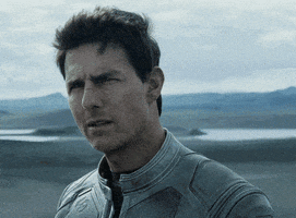 Movie gif. Tom Cruise as Jack in Oblivion stares bewildered as he shakes his head confused. Text, "What?"