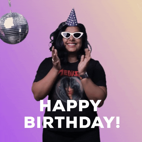 Video gif. Woman wearing a Metallica shirt and white sunglasses does a bouncy dance in front of a disco ball and purple gradient background. Text, "Happy birthday!'