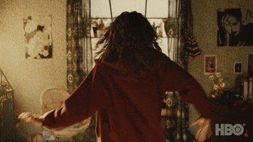 TV gif. Zendaya as Rue in Euphoria dances in her bedroom, wiggling her arms and strutting forward towards her window. She then brings her hands on her chest and gasps.