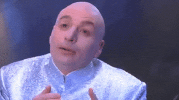 Movie gif. Mike Myers as Dr Evil in Austin Powers looking up and gesturing with his fingers and saying, "I love you! You complete me."
