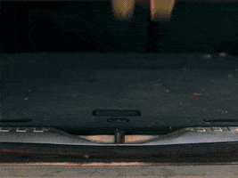 Video gif. Rear hatch of a red car slams shut and reveals a California license plate that reads, "Uh oh!"