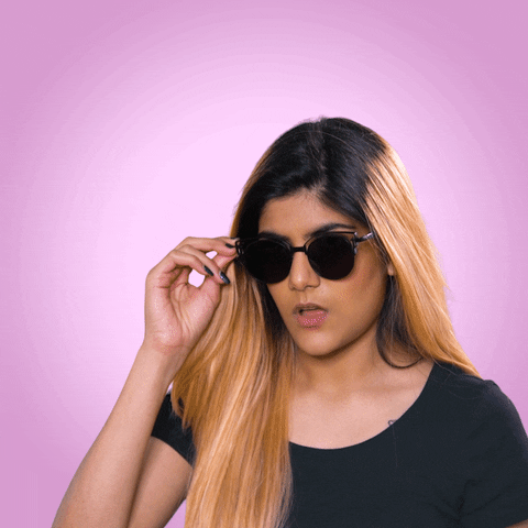 Celebrity gif. Ananya Birla lowers her sunglasses for a better look. Text, "wow."