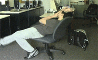 Video gif. A man falls out of his office chair, his hands on his head in frustration and his body contorting uncomfortably as he falls to the ground. He's big mad.