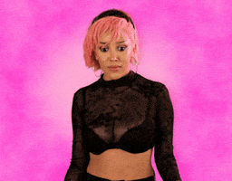 Celebrity gif. Doja Cat putting both hands on her shoulders and leaning back, mouth agape, looking us up and down with wide eyes, impressed.