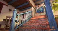 Mirabel sliding down the stairs