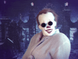 Movie gif. Pennywise from IT looks fashionable in a coat, gloves, and sunglasses. He shoots us a look over his shoulder and pulls his sunglasses down slightly, peering at us with sass.