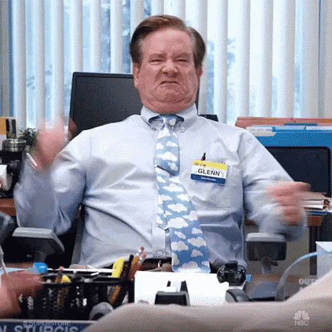 TV gif. Character Glenn Sturgis of Superstore sits at his desk and erratically punches the air in a rage tantrum.