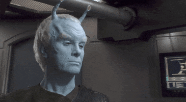 TV gif. Andorian on Star Trek: Enterprise nods once with a stern expression on his face as his pale blue antennae waft above him.