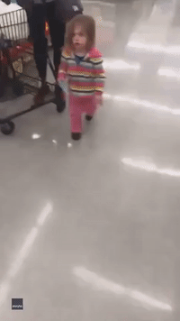 Puzzled Toddler 'Trapped' by Reflection of Lights on Grocery Store Floor