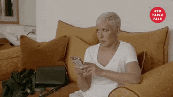 TV gif. We zoom in quickly on Adrienne Banfield-Jones on Red Table Talk as she looks up from her cell phone, giving the side-eye to someone in judgement. 