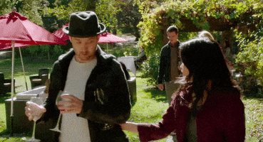TV gif. Jadyn Wong as Happy Quinn and Eddie Kaye Thomas as Toby in Scorpion. They're walking through a park and Happy Quinn suddenly grabs Toby and pulls him in for a passionate kiss.