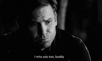 Black and white video gif. Man looks down with sorrowful eyes and says, “I miss you too, buddy.”