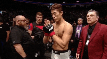 Sports gif. Dong Hyun Kim, known as Stun Gun Kim, is a fighter in UFC. It's right before he enters the ring and he has his hands in a prayer position. His eyes are closed as he prays before his fight begins. 