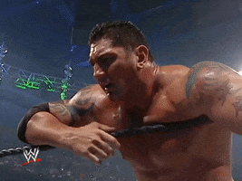 Sports gif. A distressed wrestler on the ropes holds his head in his hands.