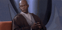 Star Wars gif. Samuel L Jackson as Mace Windu. He sits with his fingers pressed together and he contemplates. He sighs and shakes his head slowly in disappointment.