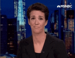TV gif. Rachel Maddow on her show smirks as she nods her head knowingly. 