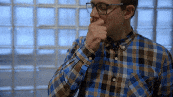 Video gif. A man puts his hands on his chin in a thinking position and rubs hard, thinking long and deep.