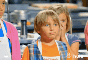Reality TV gif. A contestant on Masterclass Junior. He's heard some bad news and he hiccups as he tries to hold in his tears. The tears overcome him and he ends up covering his face with his hand, squeezing his eyes together.