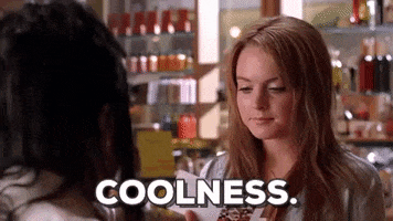Movie gif. Lindsay Lohan as Cady in "Mean Girls" turns something over in her hand and looks at it discerningly, then looks up. Text, "Coolness."