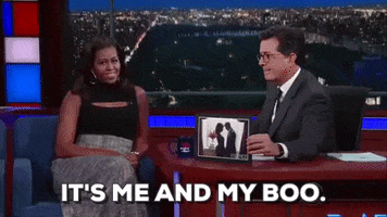 TV gif. Michelle Obama on Late Night with Stephen Colbert looks at a picture that Stephen holds up. Text, "It's me and my boo."